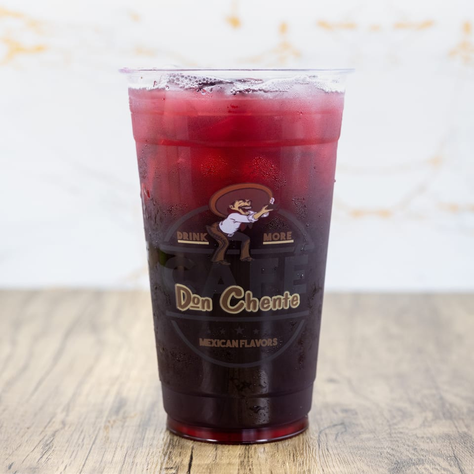 A clear plastic cup of iced red drink with the Don Chente Mexican Flavors logo.